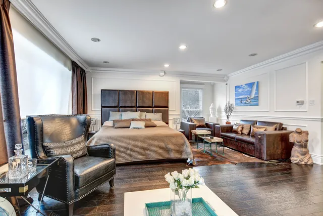 a bed room with furniture and a flat screen tv