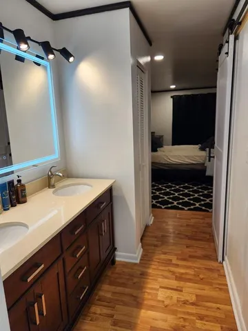 a bathroom with a sink a toilet a mirror and shower