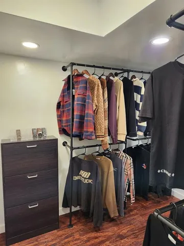 a view of walk in closet with clothes