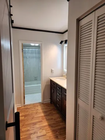 a bathroom with a double vanity sink a mirror and a bathtub