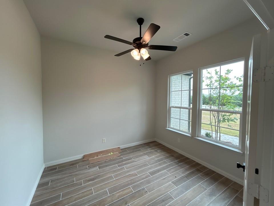 8861 County Road 623 Blue Ridge, TX 75424 - Photo 5 of 20 a view of empty room with wooden floor and fan