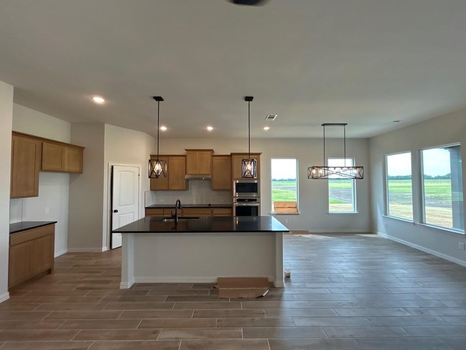 8861 County Road 623 Blue Ridge, TX 75424 - Photo 9 of 20 a large kitchen with stainless steel appliances kitchen island a large counter top and a wooden floors