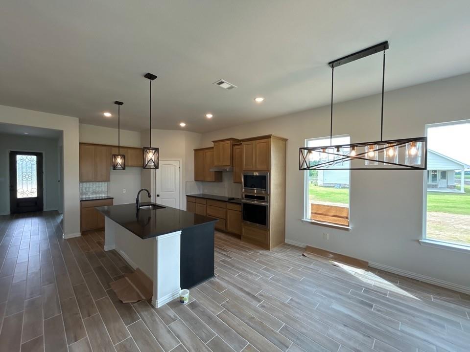8861 County Road 623 Blue Ridge, TX 75424 - Photo 10 of 20 a kitchen with stainless steel appliances kitchen island granite countertop a stove a sink and a refrigerator