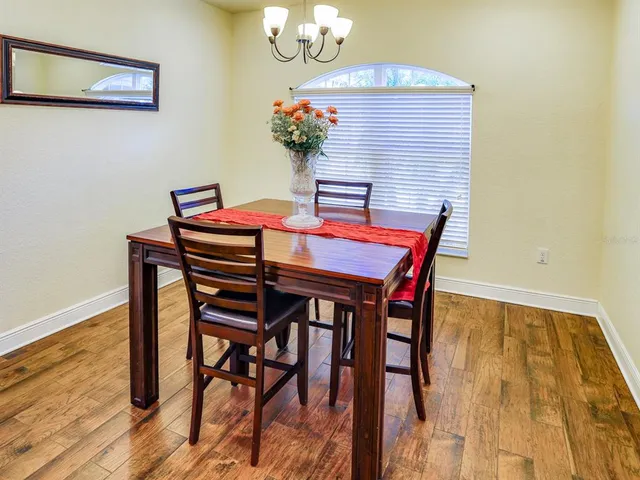 a dining room with furniture and wooden floor