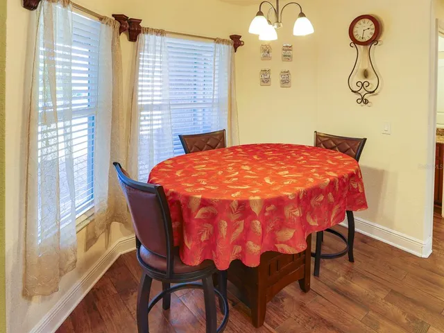 a view of a backyard with table and chairs under an umbrella