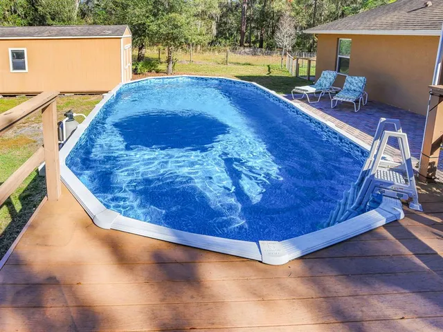 a backyard of a house with an outdoor space and seating area