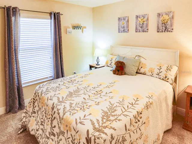 a bedroom with bed and a potted plant