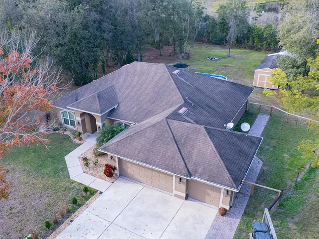 an aerial view of a house with garden space and street view