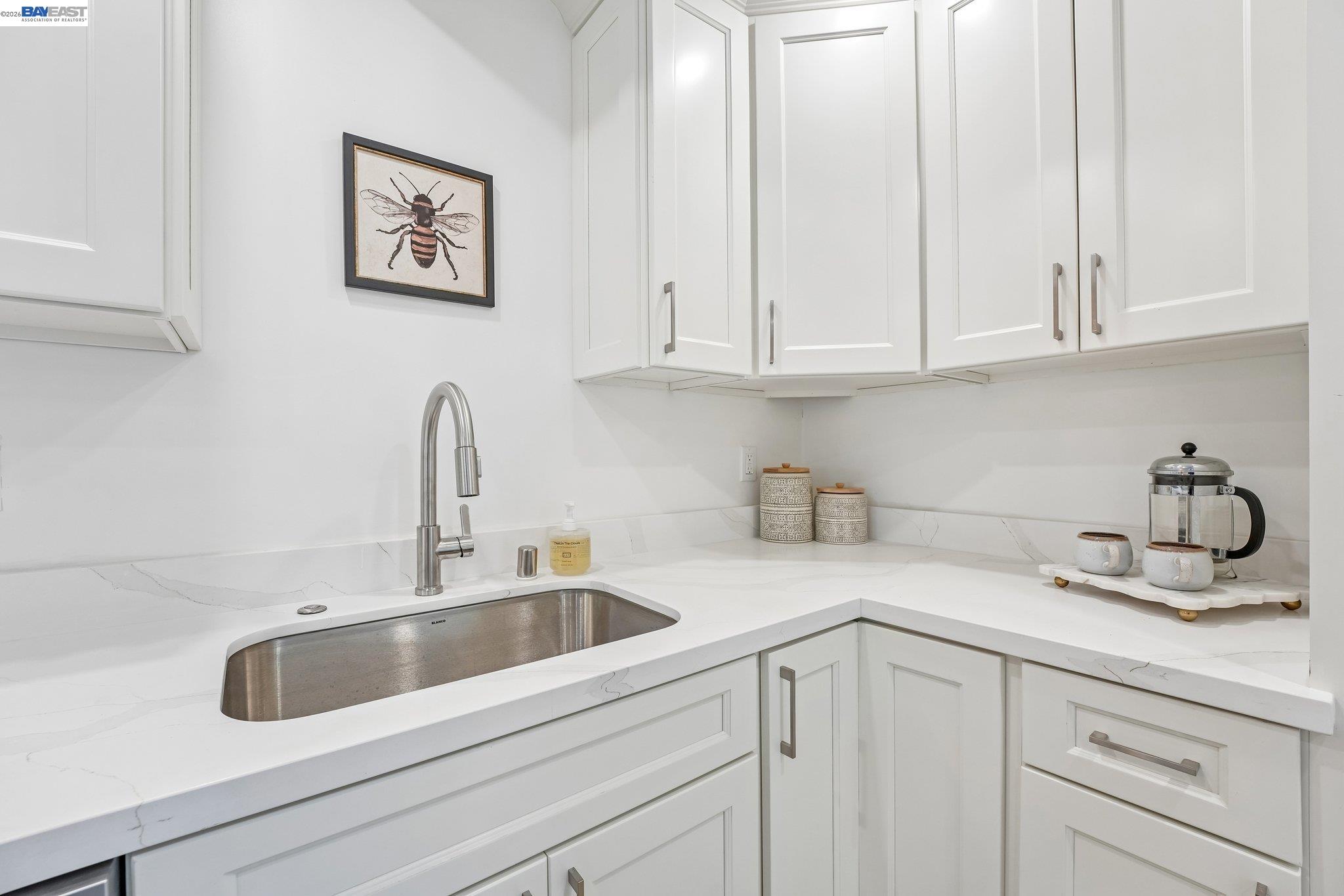 606 West 9th Street Santa Rosa, CA 95401 - Photo 31 of 52 a kitchen with white cabinets and a sink