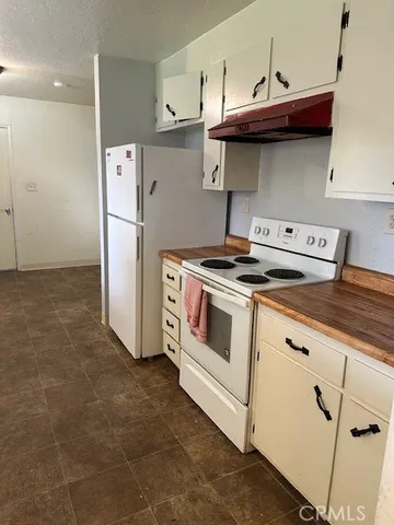 a kitchen with a stove and a refrigerator