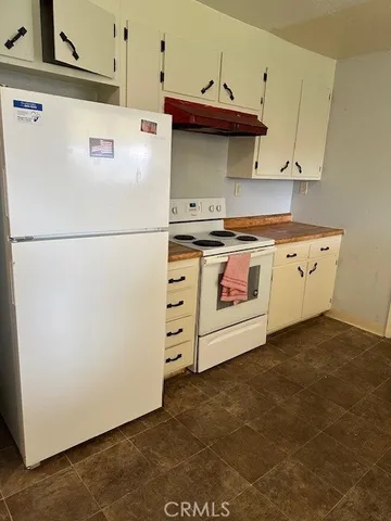 a white refrigerator freezer sitting inside of a kitchen