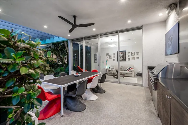 a living room with furniture and a book shelf