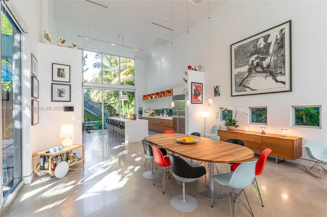a living room with patio furniture and a chandelier
