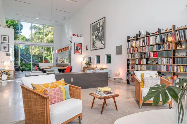 a living room with furniture a flat screen tv and a large window