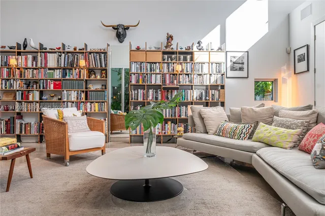 a bedroom with a bed couch and dresser