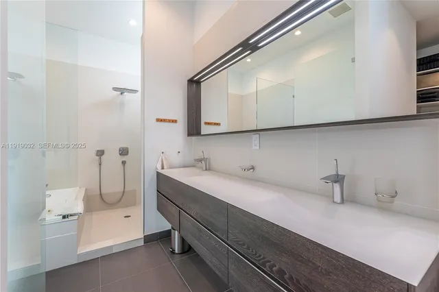 a kitchen with stainless steel appliances a dining table and chairs