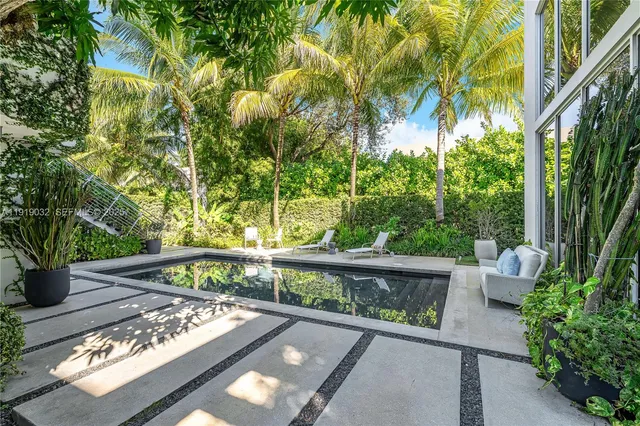 a view of a backyard with plants and a patio