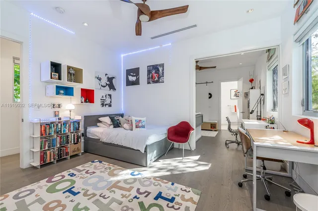 a bed sitting in a room next to a window