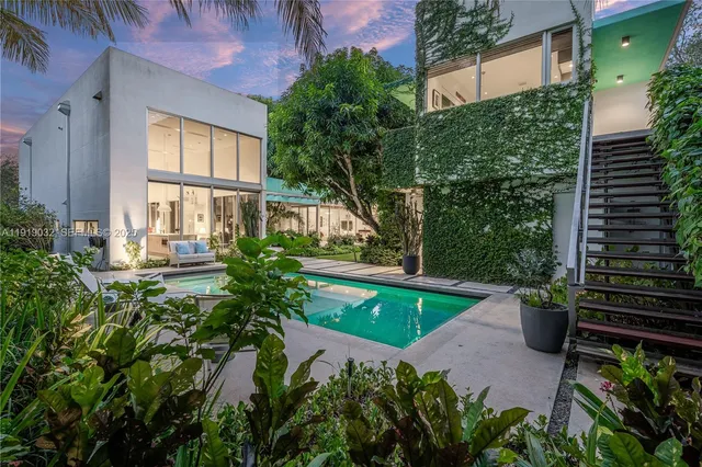 a view of a patio with table and chairs and potted plants
