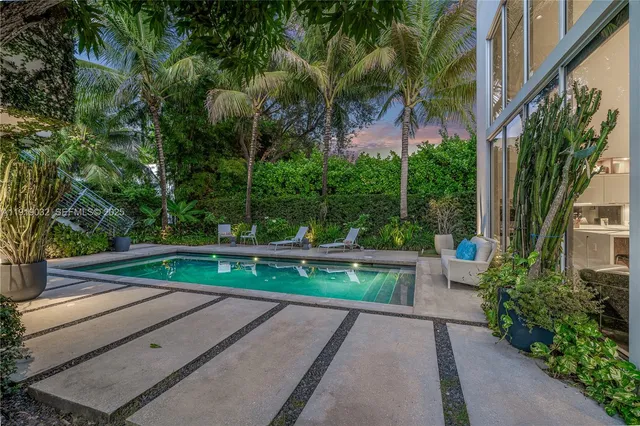a view of yard from deck with patio