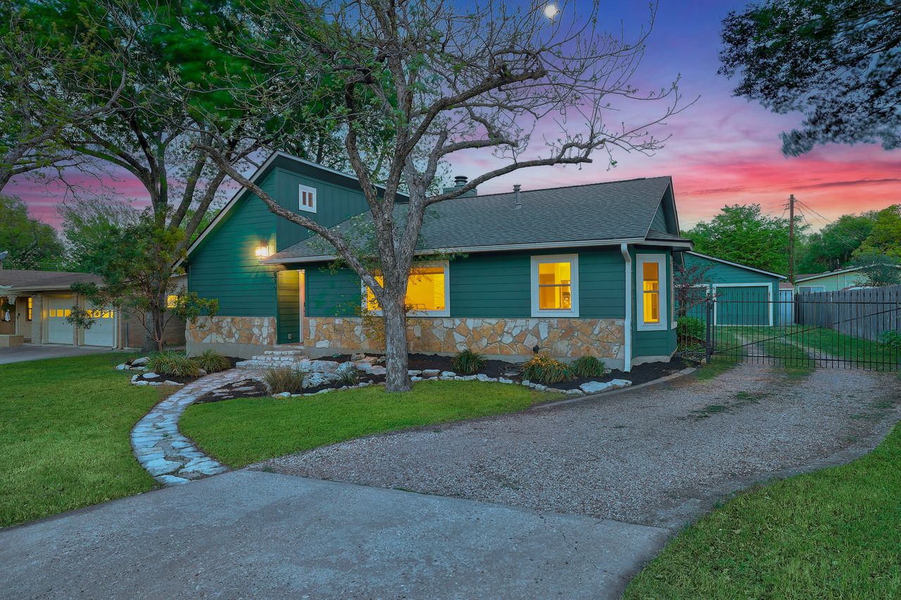 6903 Ardath Street Austin, TX 78757 - Photo 2 of 40 View of front facade with stone siding, driveway, and an outdoor structure