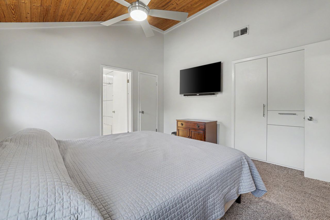 6903 Ardath Street Austin, TX 78757 - Photo 21 of 40 Carpeted bedroom featuring a vaulted wood ceiling and a ceiling fan