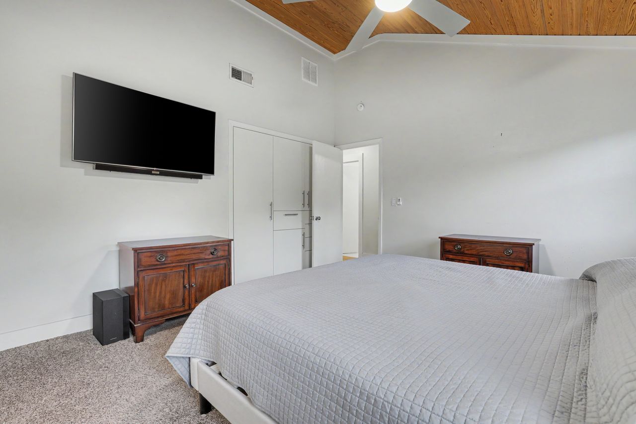 6903 Ardath Street Austin, TX 78757 - Photo 22 of 40 Bedroom with a vaulted wood ceiling, light colored carpet, ceiling fan, and crown molding