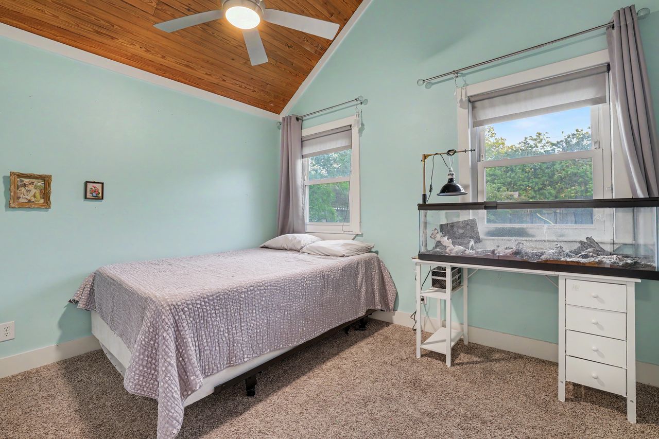 6903 Ardath Street Austin, TX 78757 - Photo 26 of 40 Bedroom featuring carpet, a vaulted wooden ceiling, and a ceiling fan