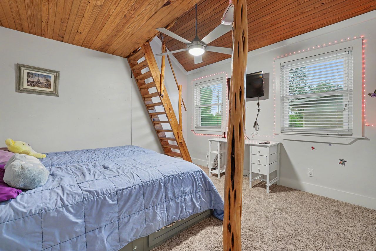 6903 Ardath Street Austin, TX 78757 - Photo 30 of 40 Bedroom with light carpet, wood ceiling, and ceiling fan