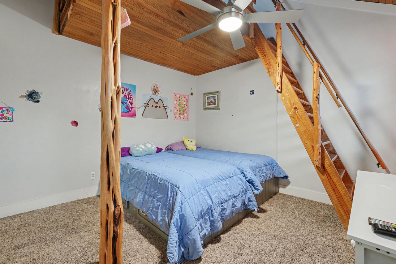 6903 Ardath Street Austin, TX 78757 - Photo 31 of 40 Bedroom with wooden ceiling, light colored carpet, and a ceiling fan
