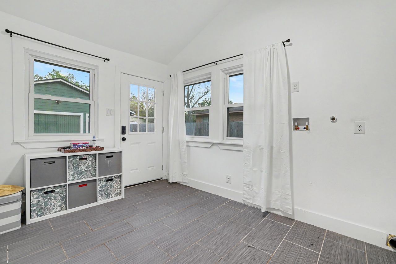 6903 Ardath Street Austin, TX 78757 - Photo 33 of 40 Doorway featuring lofted ceiling and wood tiled floors