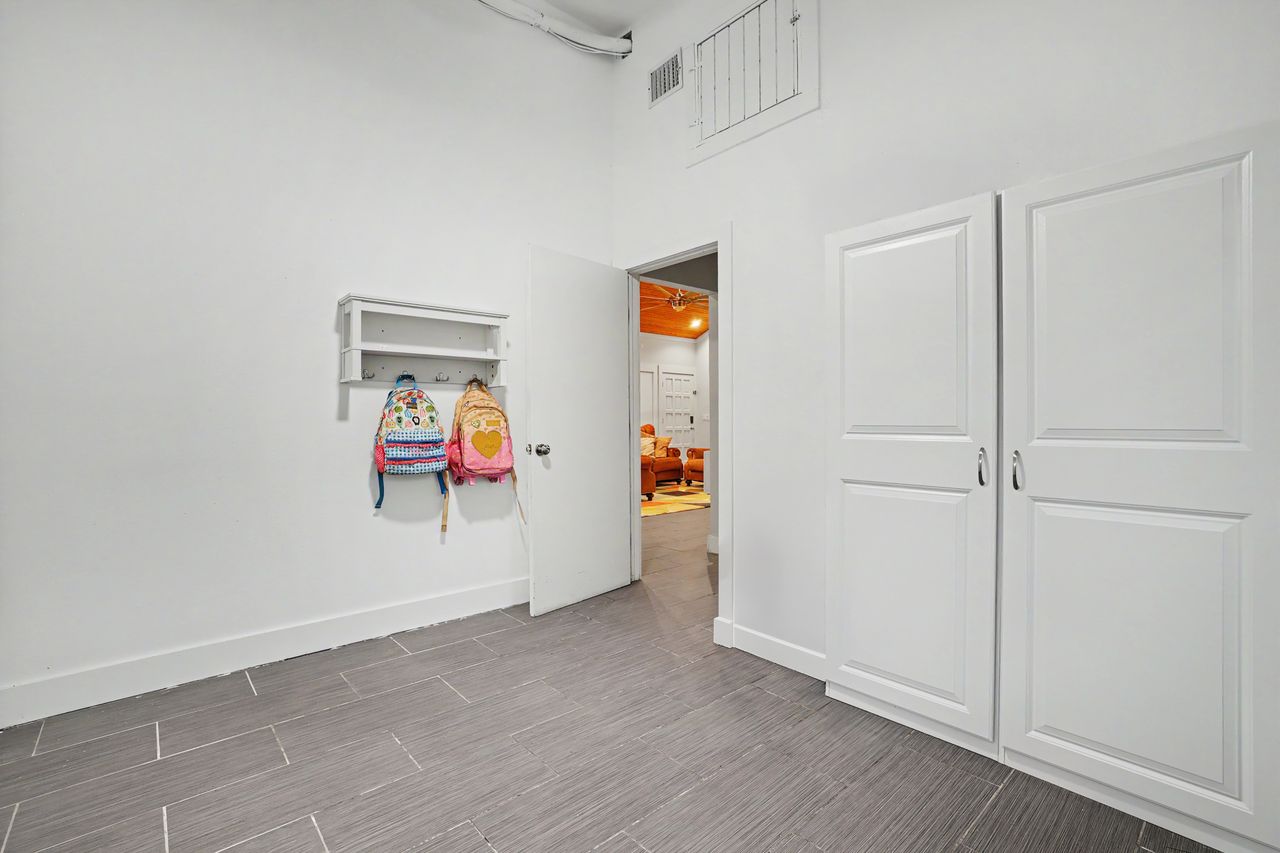 6903 Ardath Street Austin, TX 78757 - Photo 34 of 40 Bedroom featuring wood finish floors and a high ceiling