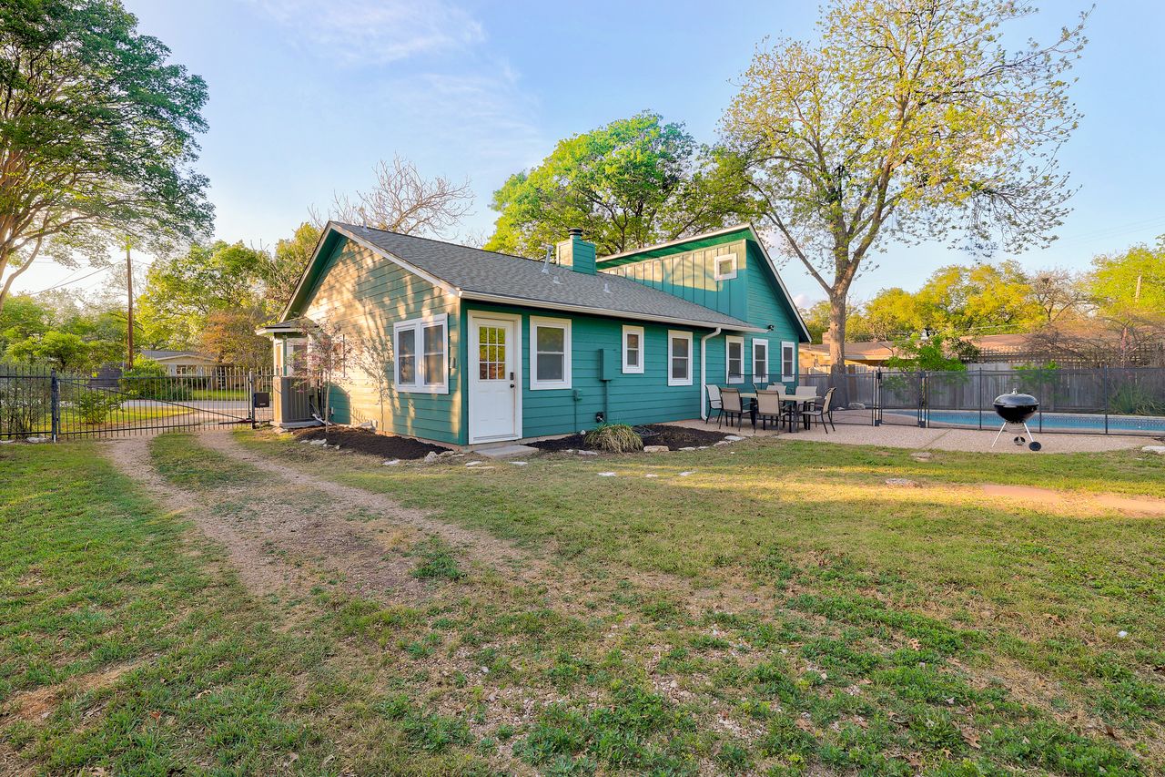 6903 Ardath Street Austin, TX 78757 - Photo 36 of 40 Back of house featuring a chimney and a patio