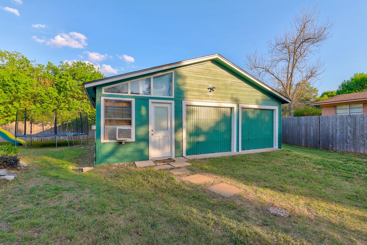 6903 Ardath Street Austin, TX 78757 - Photo 37 of 40 View of outbuilding with a trampoline and a garage