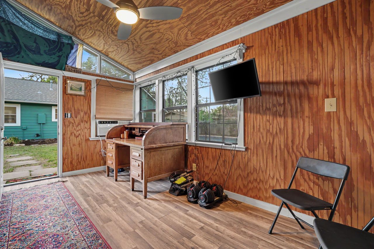 6903 Ardath Street Austin, TX 78757 - Photo 38 of 40 Office space with wood walls, light wood-style flooring, a ceiling fan, and vaulted ceiling