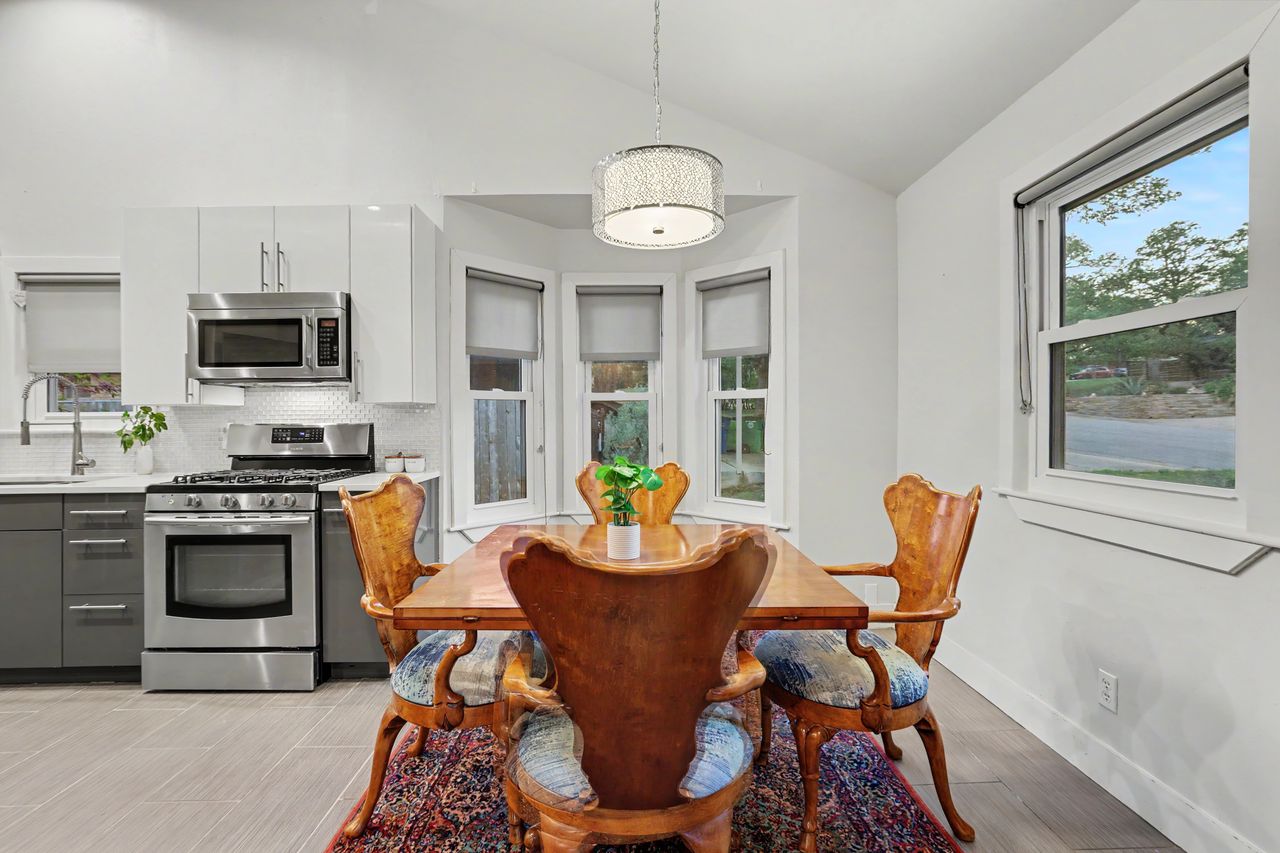 6903 Ardath Street Austin, TX 78757 - Photo 10 of 40 Dining room with lofted ceiling and baseboards