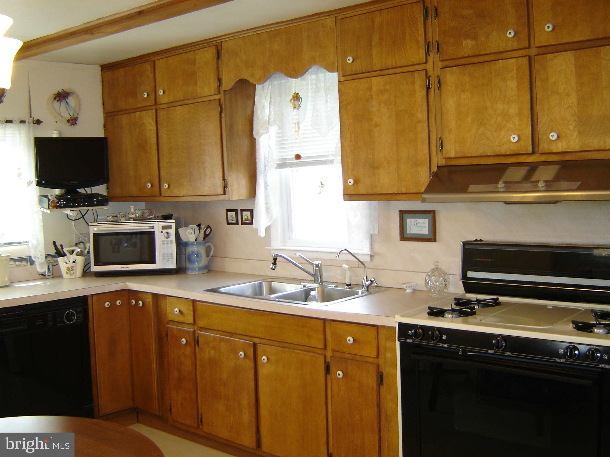 15312 Old Hanover Road Upperco, MD 21155 - Photo 6 of 19 a kitchen with a sink a stove and cabinets