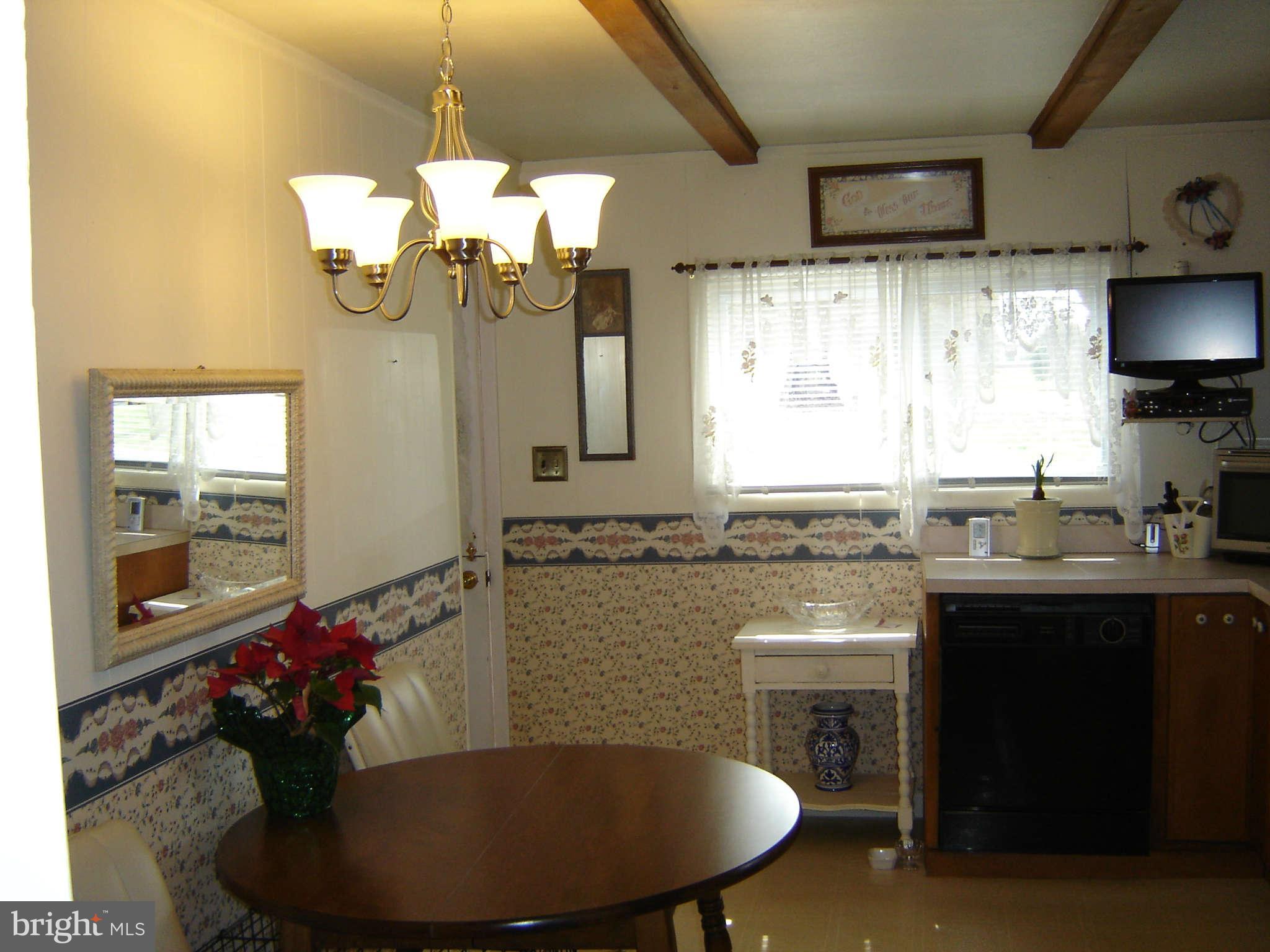15312 Old Hanover Road Upperco, MD 21155 - Photo 7 of 19 a kitchen with a chandelier sink cabinets and appliances