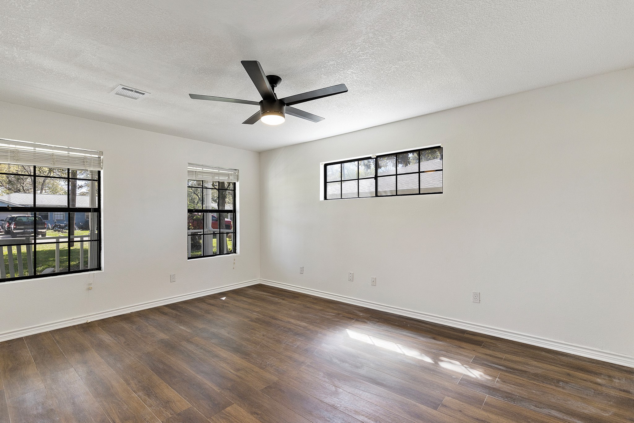 504 Percival Street, Unit A Tomball, TX 77375 - Photo 13 of 26 a view of empty room with wooden floor and fan