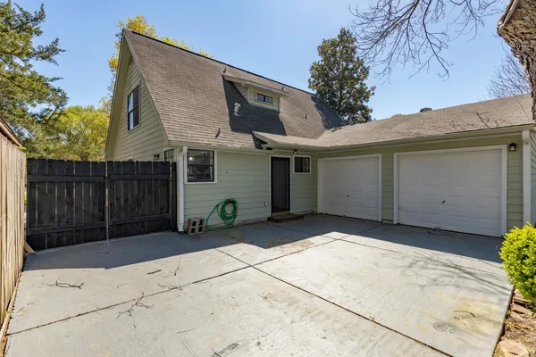 a view of a house with wooden fence