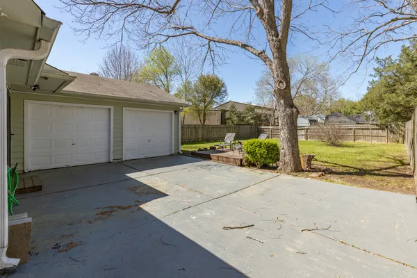 a view of a house with a yard and tree