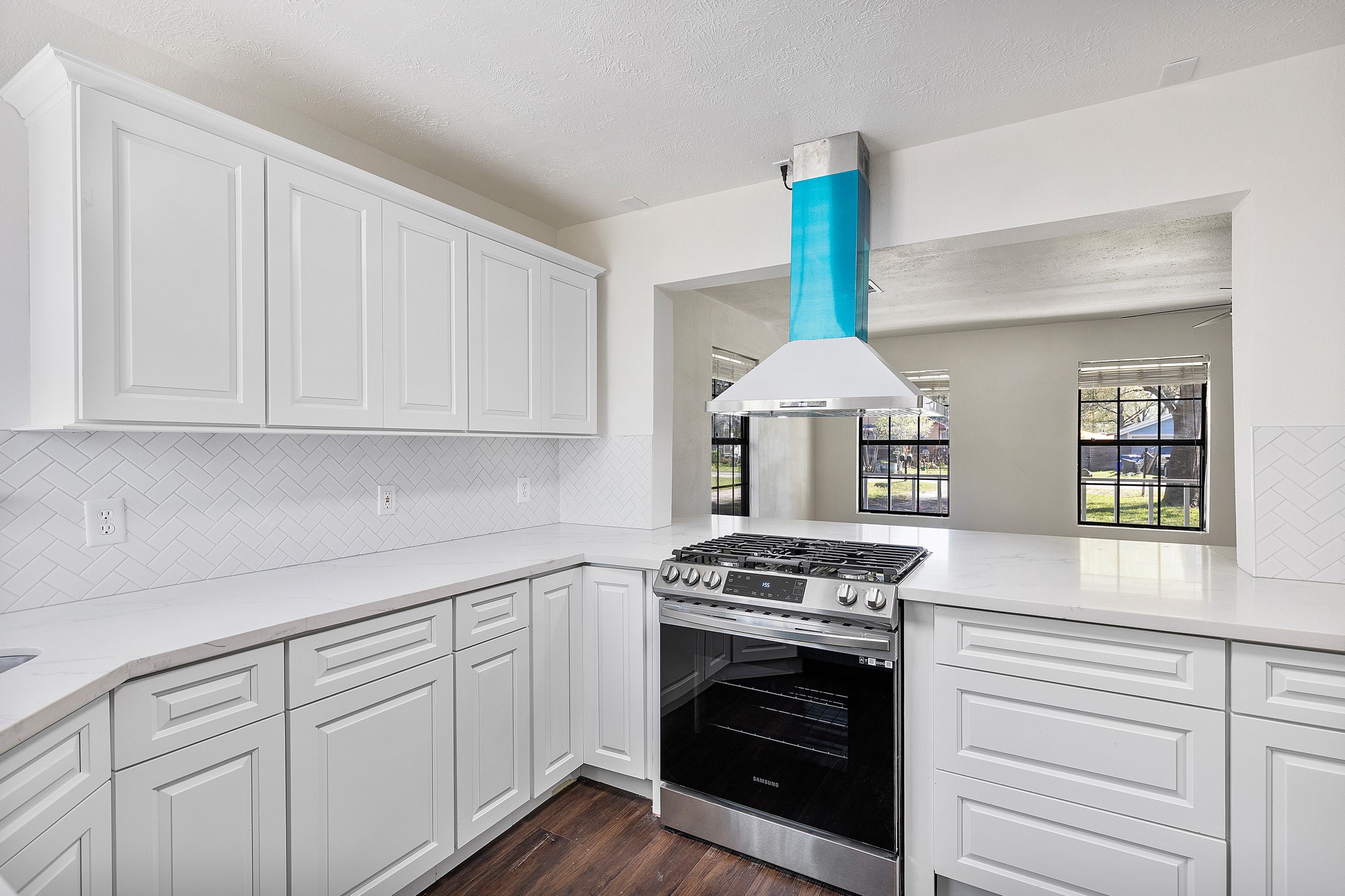 504 Percival Street, Unit A Tomball, TX 77375 - Photo 25 of 26 a kitchen with white cabinets and a stove top oven