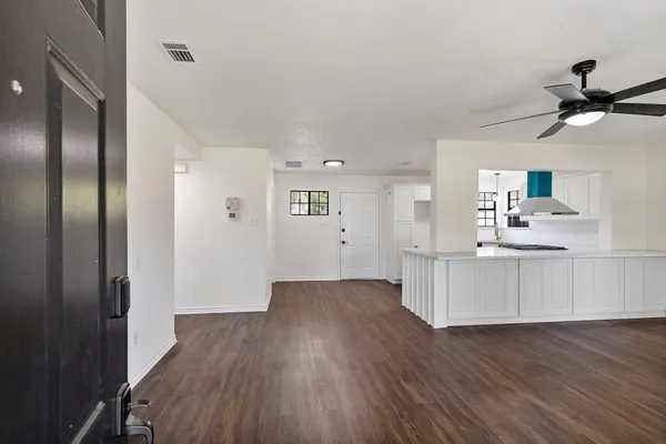 a view of a kitchen with wooden floor and a kitchen