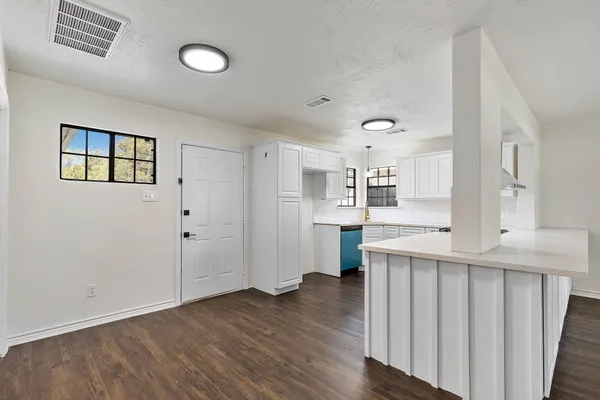 a view of kitchen with wooden floor and electronic appliances