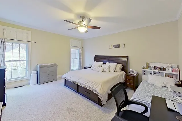 a bedroom with a bed and a chandelier