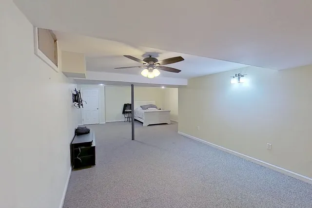 a living room with furniture and a ceiling fan