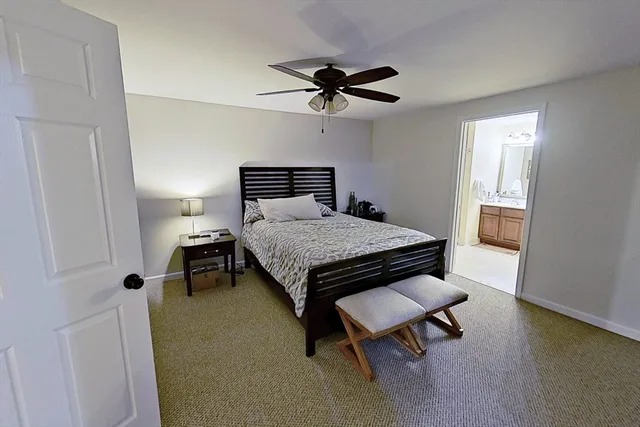 a bedroom with a bed and a table in it