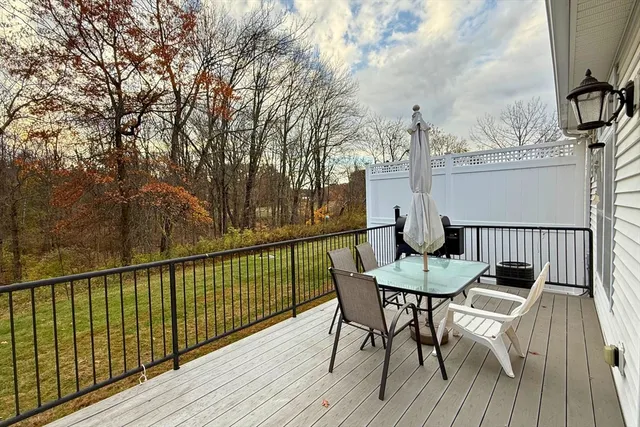 a view of a deck with furniture and wooden floor