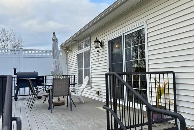 a view of a patio with a table and chairs and wooden floor