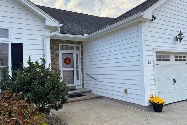 a front view of a house with outdoor seating